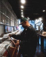 A friendly shop owner carefully inspecting a rare vinyl record.