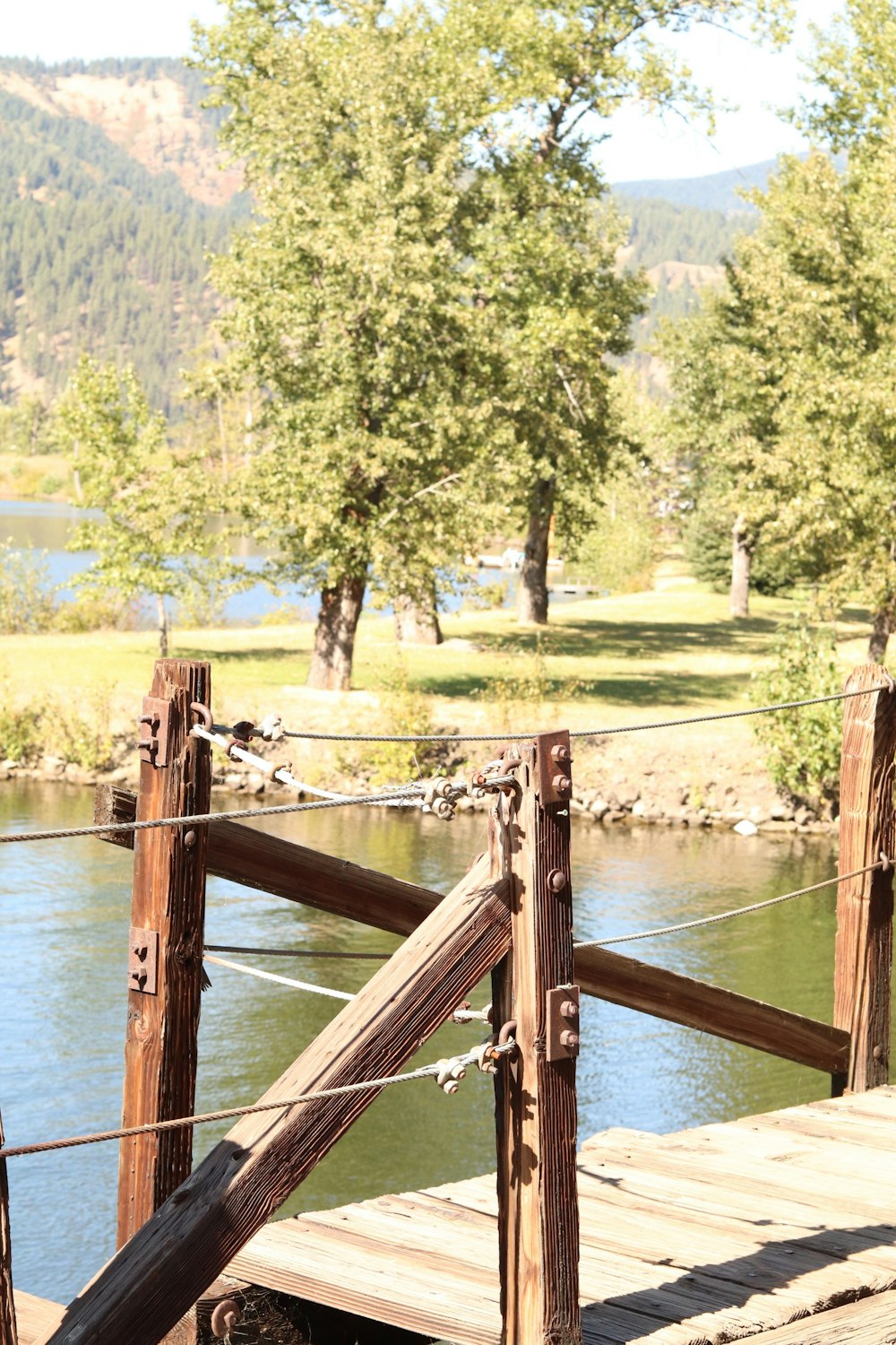 brown wooden fence on lake during daytime