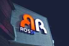 a close up of a neon sign on the side of a building