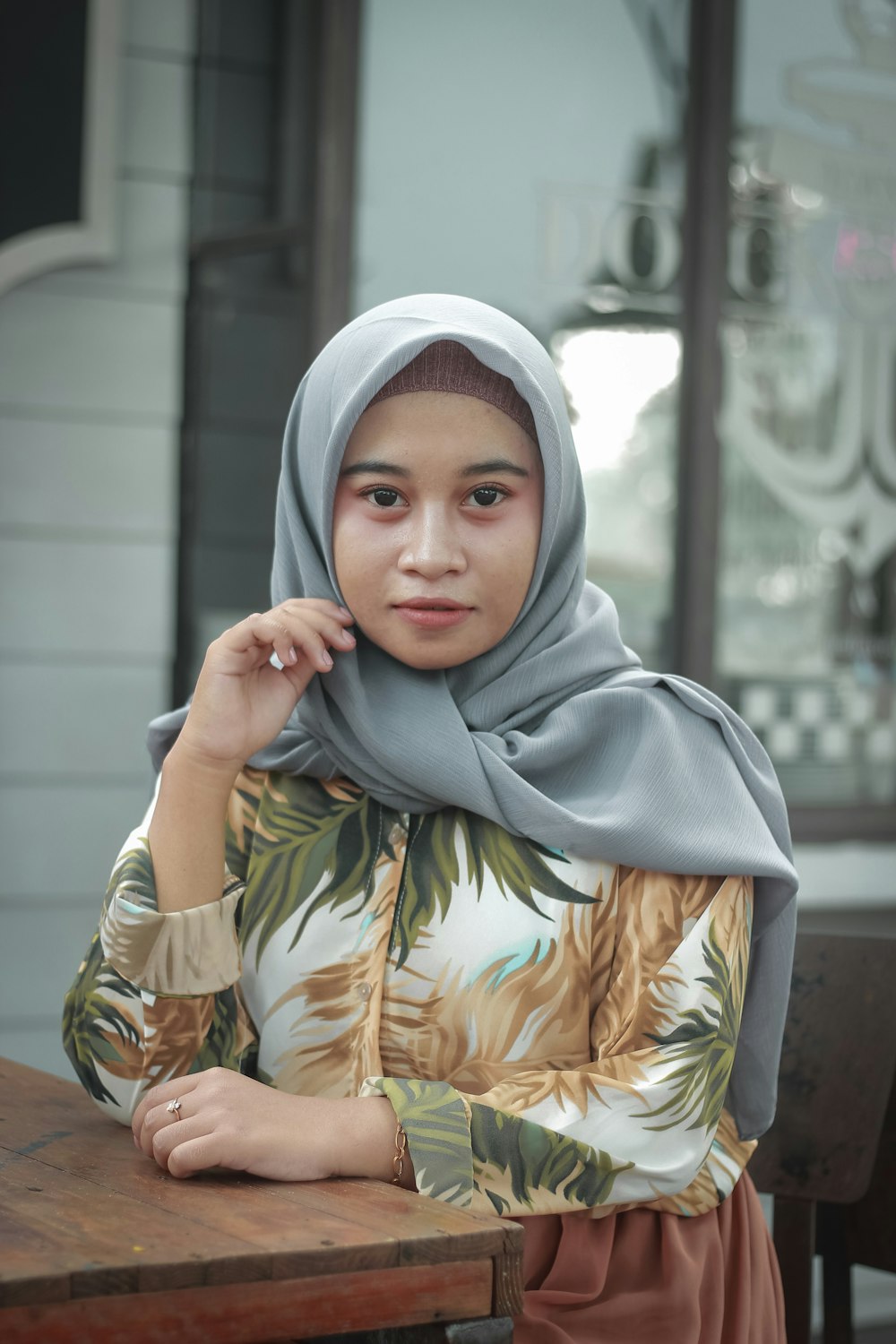 woman in gray hijab and brown and white floral hijab