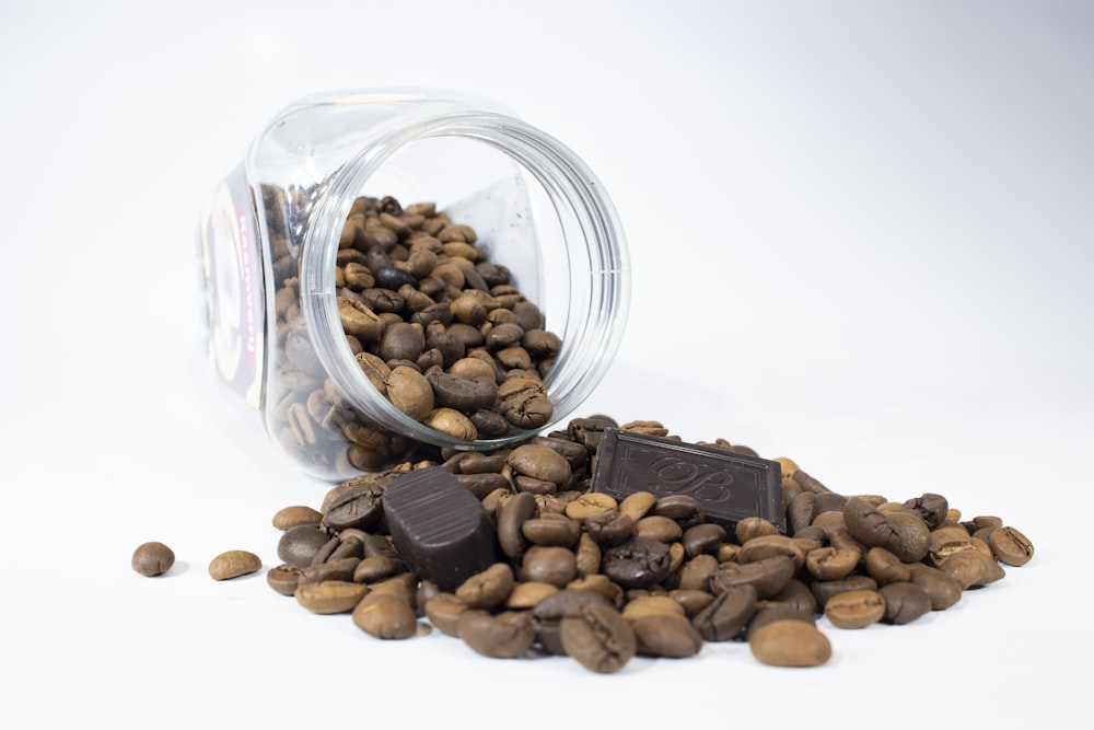 brown almond nuts in clear glass jar