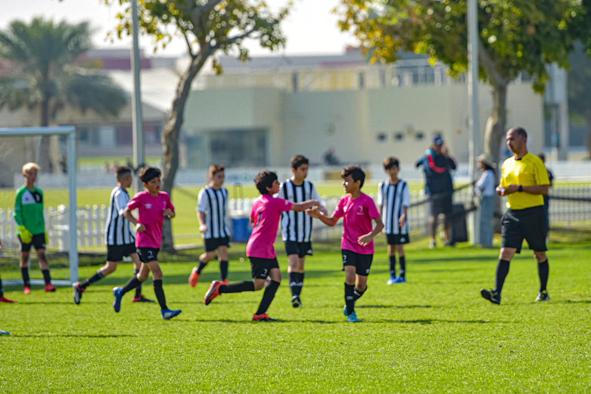 Youth soccer team in red and white uniforms on a grass field