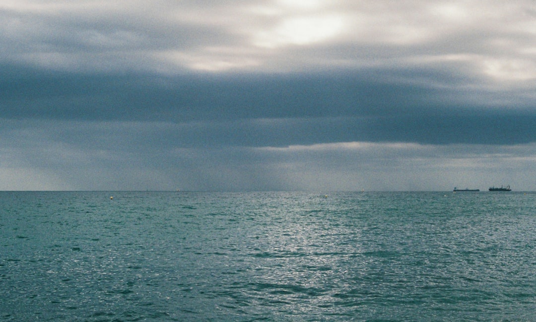 body of water under cloudy sky during daytime