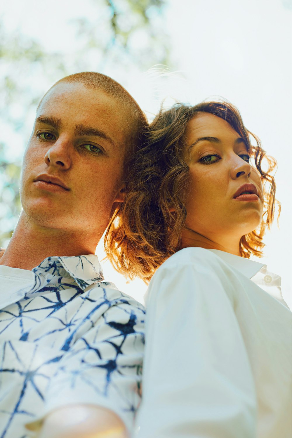 man in white and blue floral button up shirt beside woman in white shirt