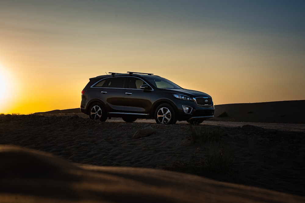 black bmw x series on desert during sunset