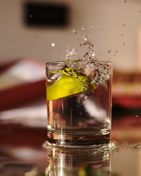 clear drinking glass with ice and lemon