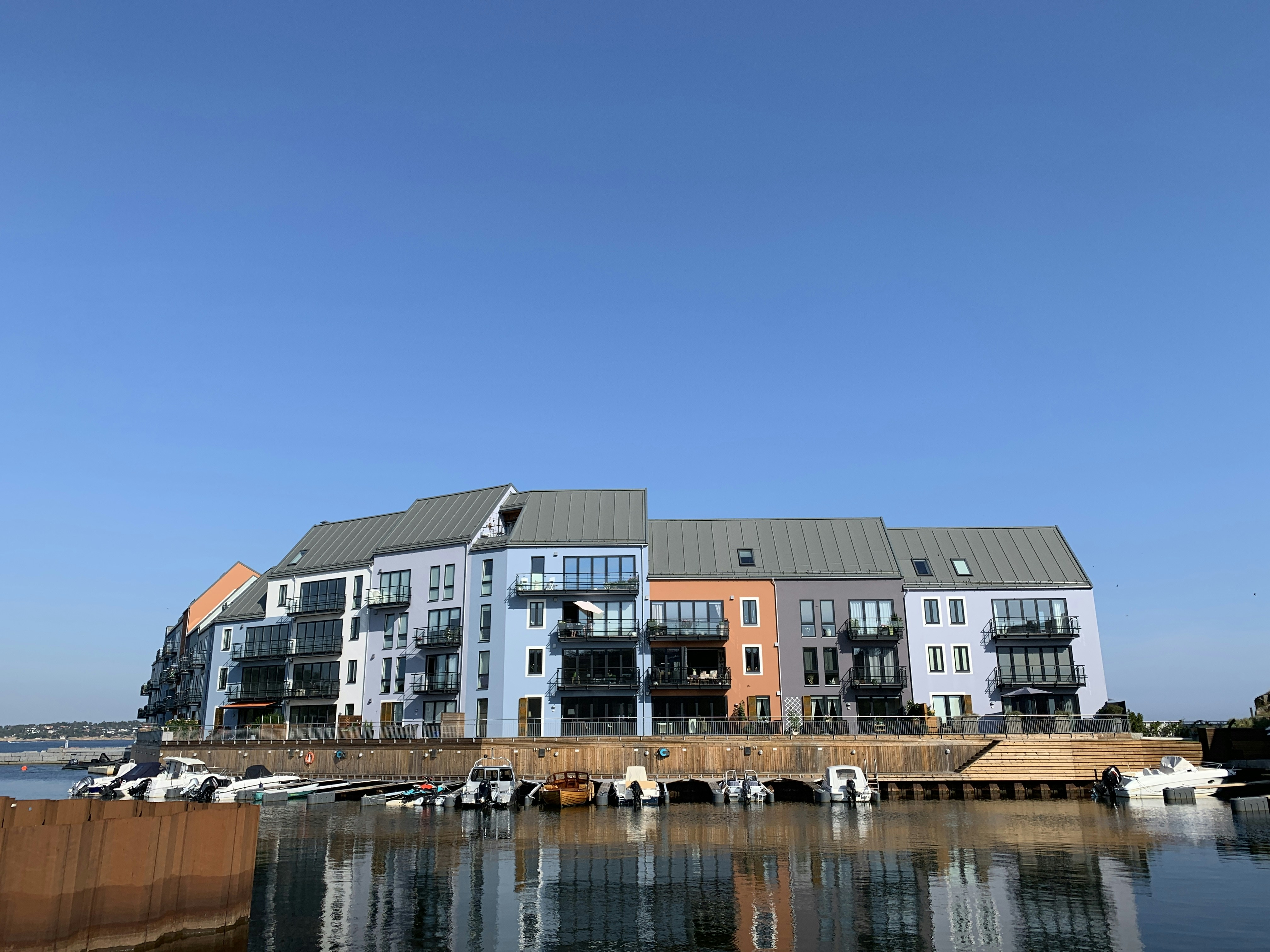 white and brown concrete building beside body of water during daytime