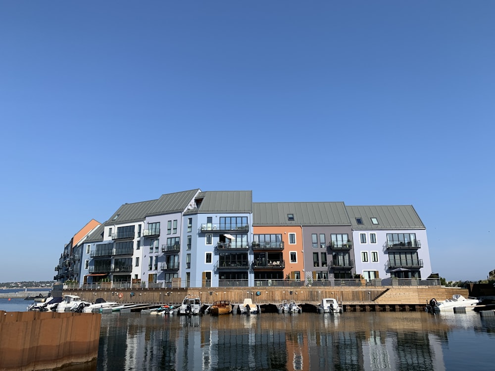 white and brown concrete building beside body of water during daytime