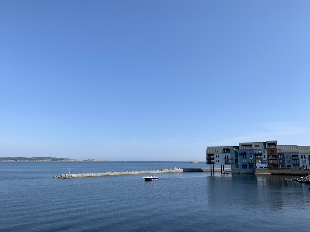 white and blue building on sea shore during daytime