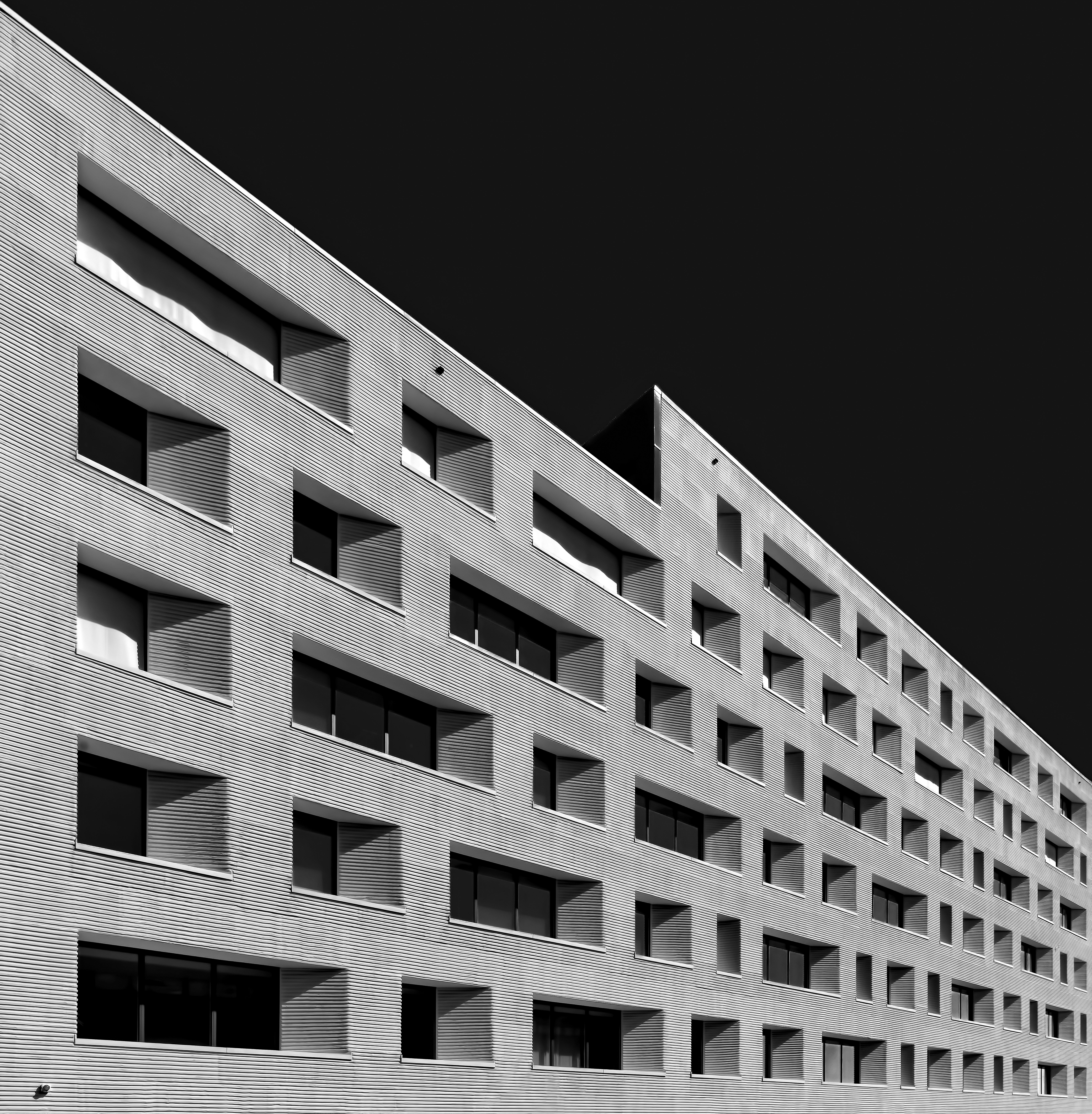 grayscale-photo-of-concrete-building