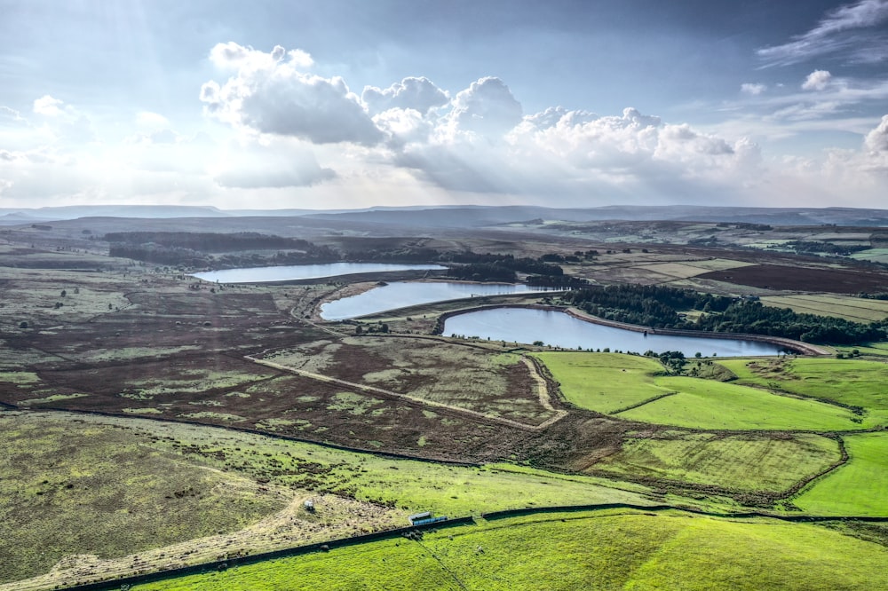 aerial view of green grass field near body of water during daytime