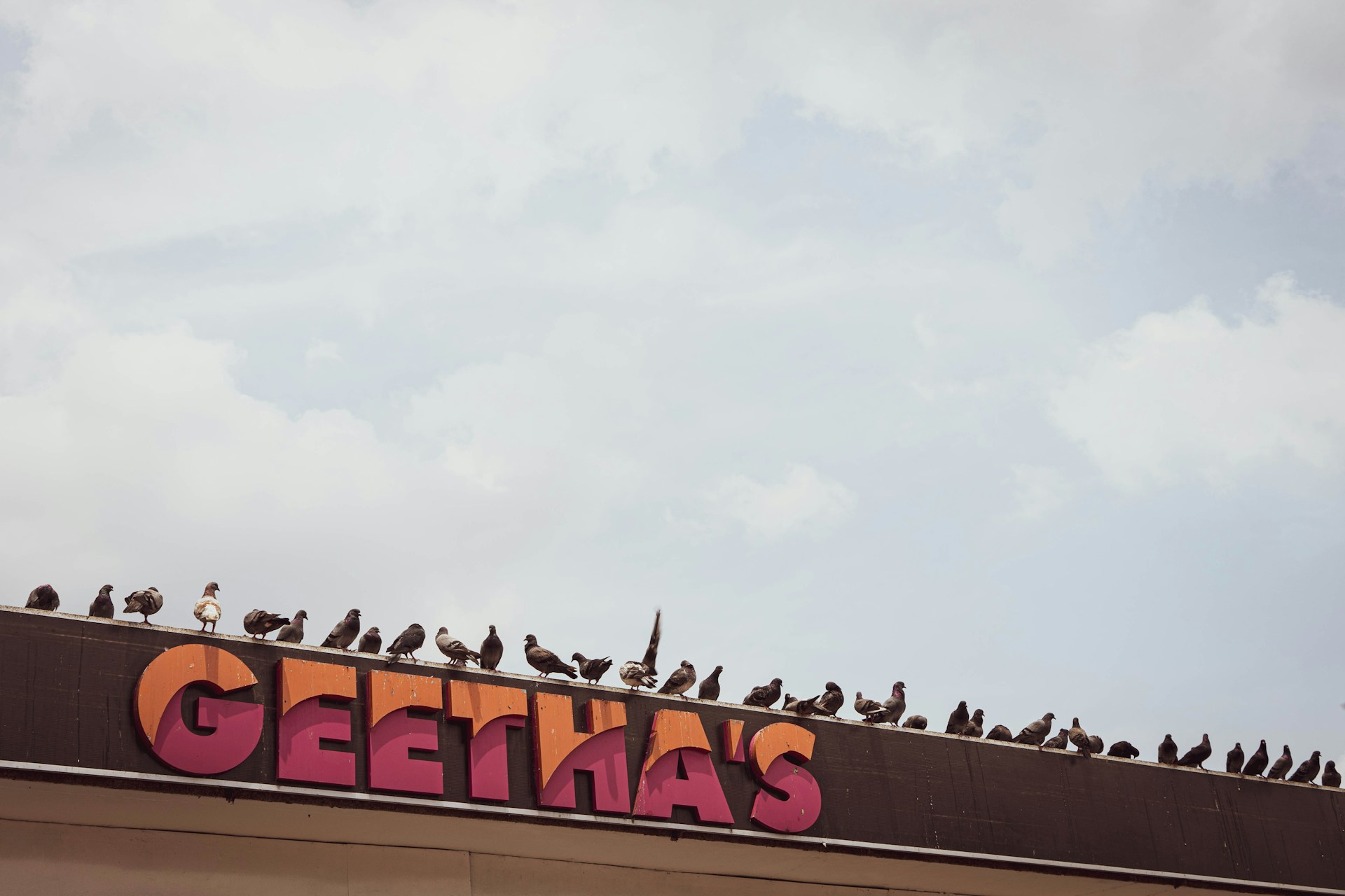 woman wearing yellow long-sleeved dress under white clouds and blue sky during daytime