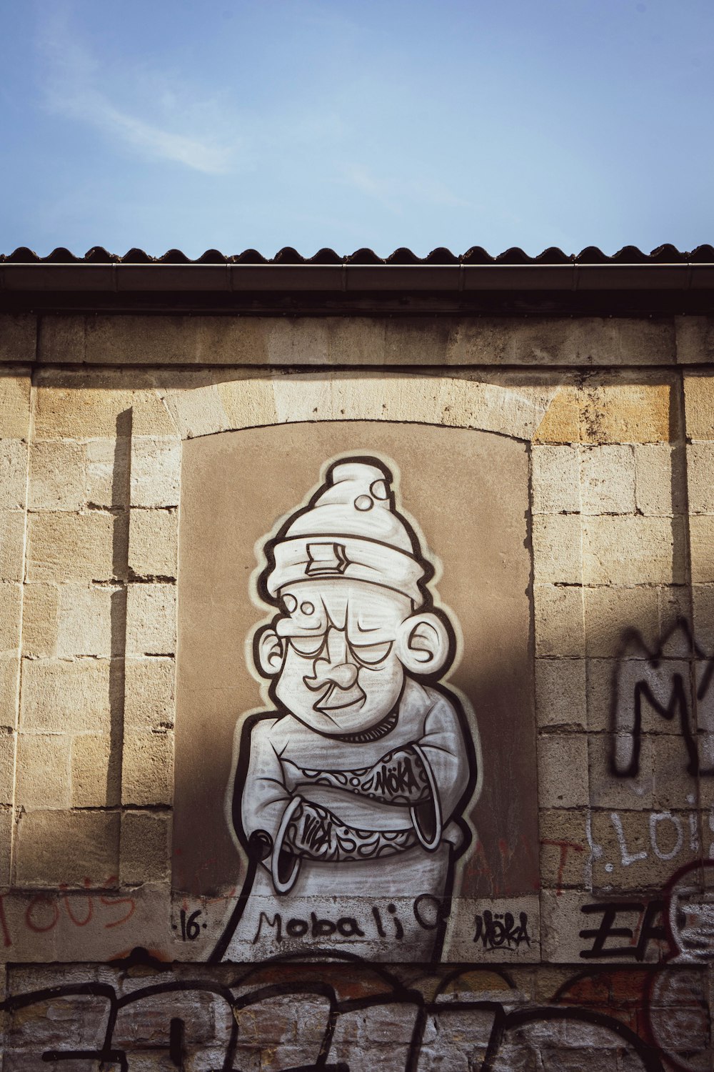 gray concrete wall with womans face carved