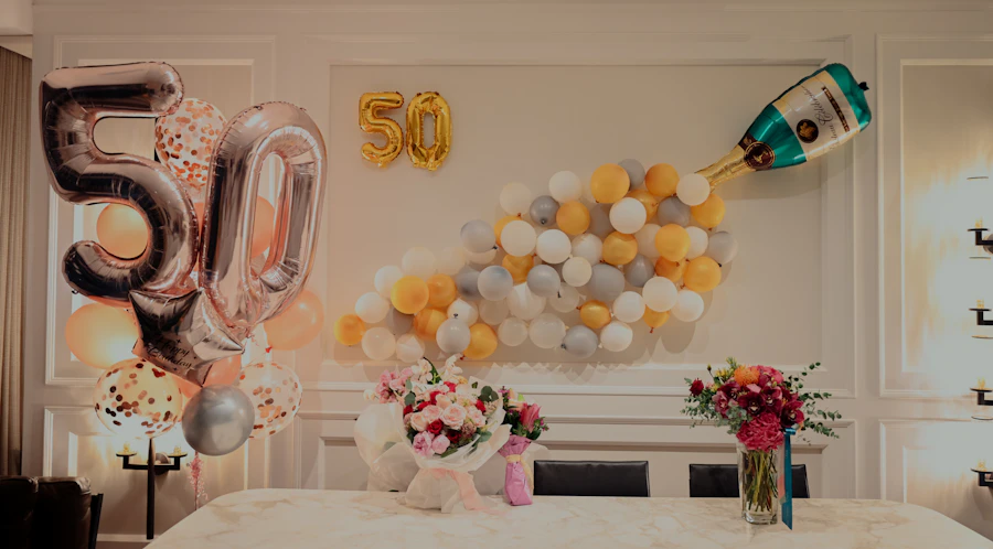 Milestone birthday celebration styled with gold and ivory balloons and florals