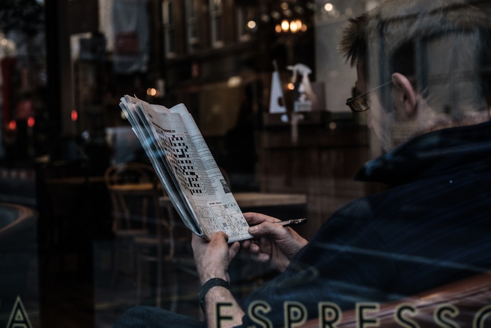 person reading newspaper during night time