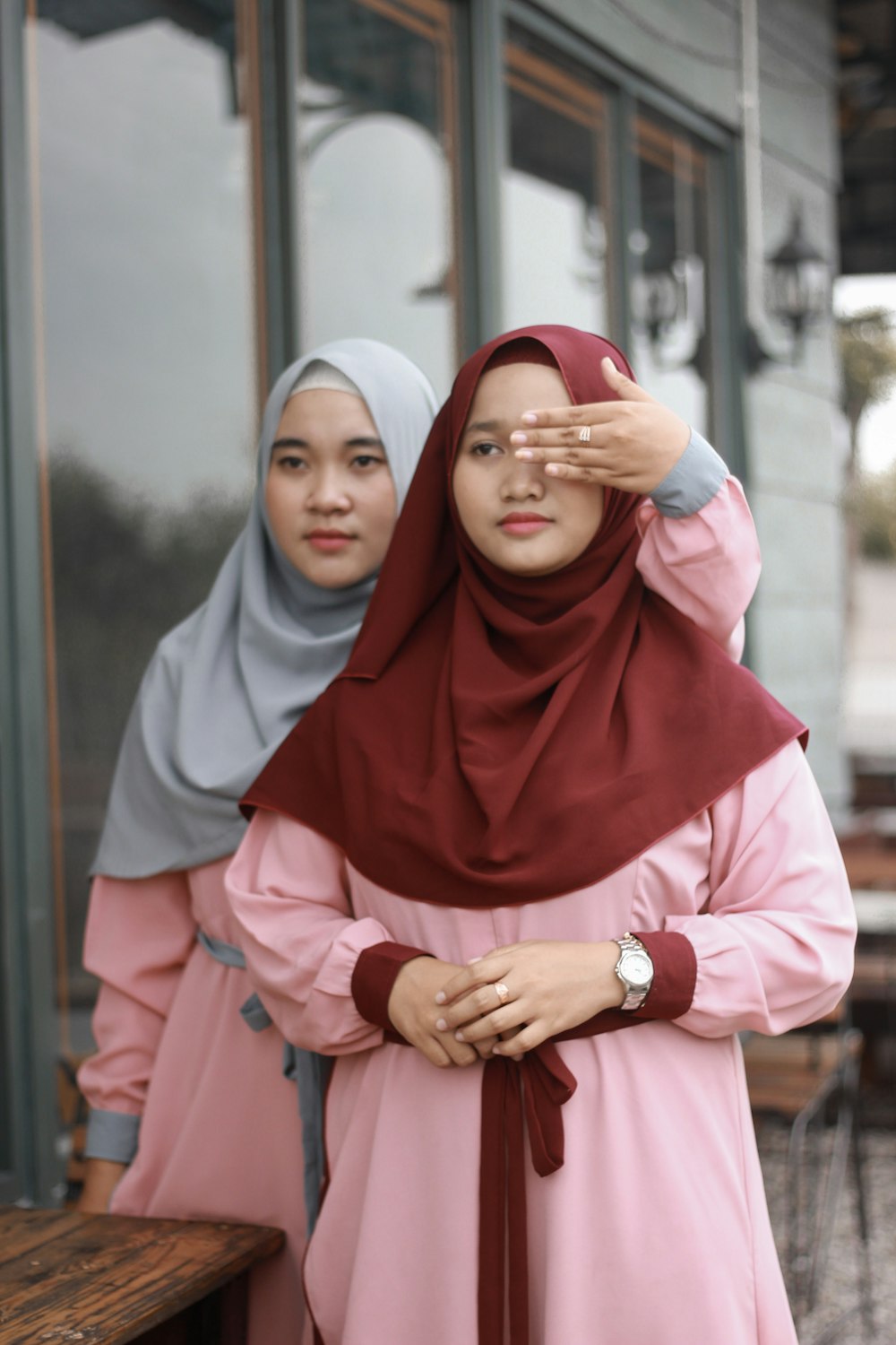 woman in red hijab and pink abaya