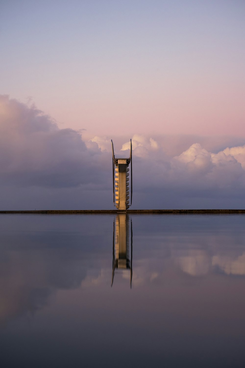 body of water under cloudy sky during daytime