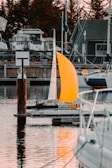 white sail boat on dock during daytime