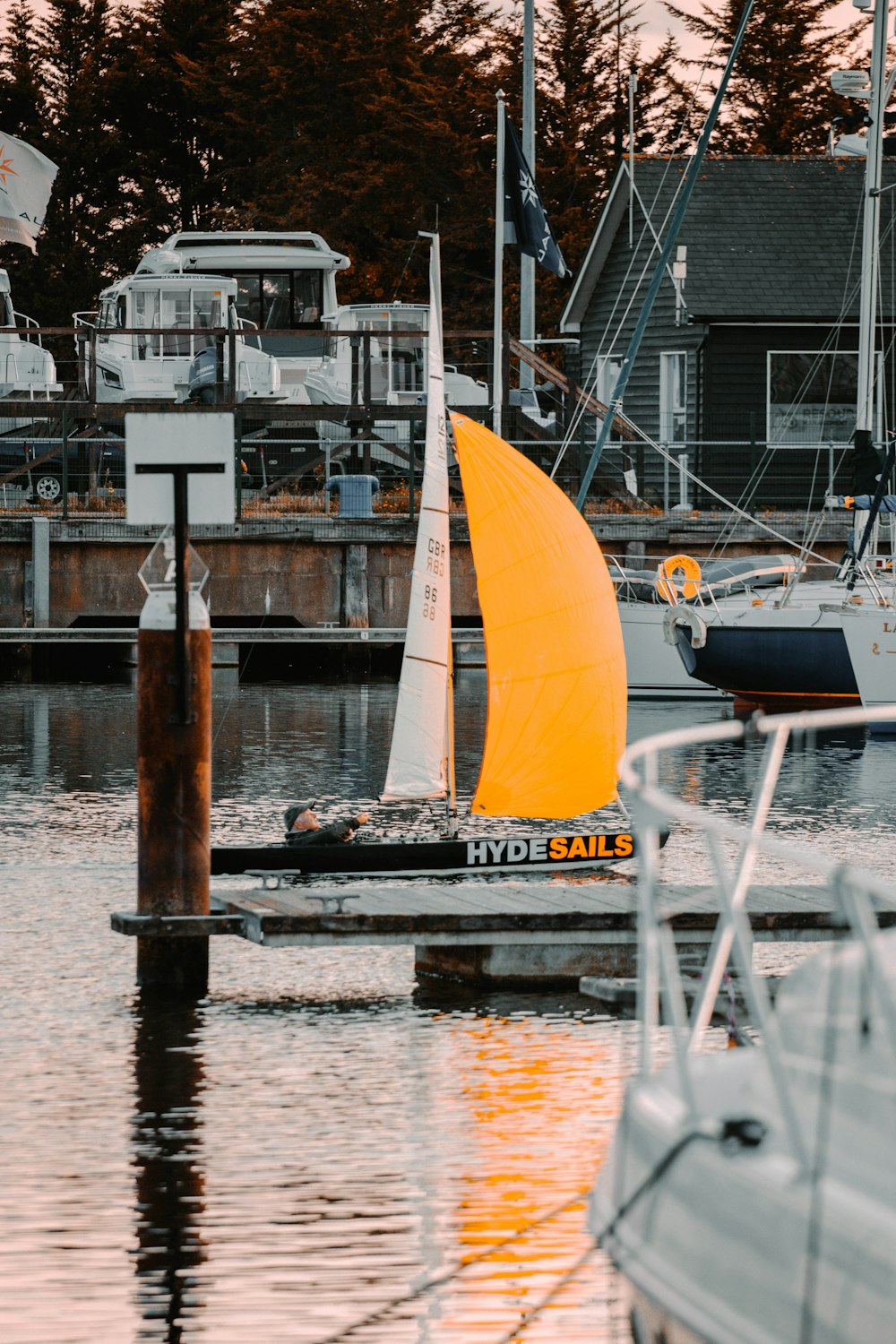 white sail boat on dock during daytime