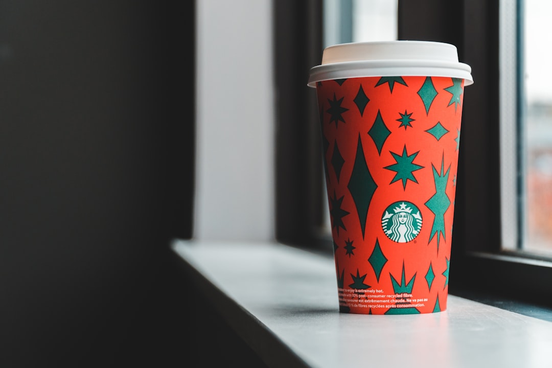 red and white disposable cup on white table