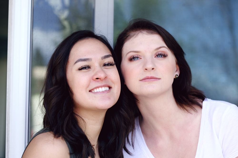 woman in white tank top beside woman in white tank top