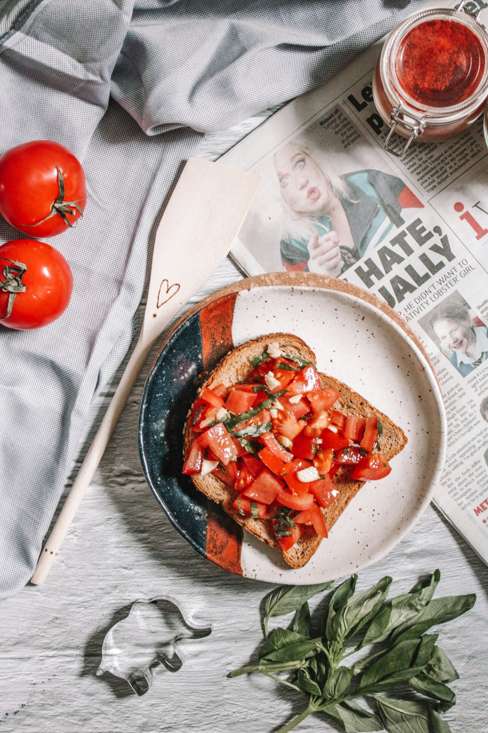 red tomato on white and black ceramic bowl