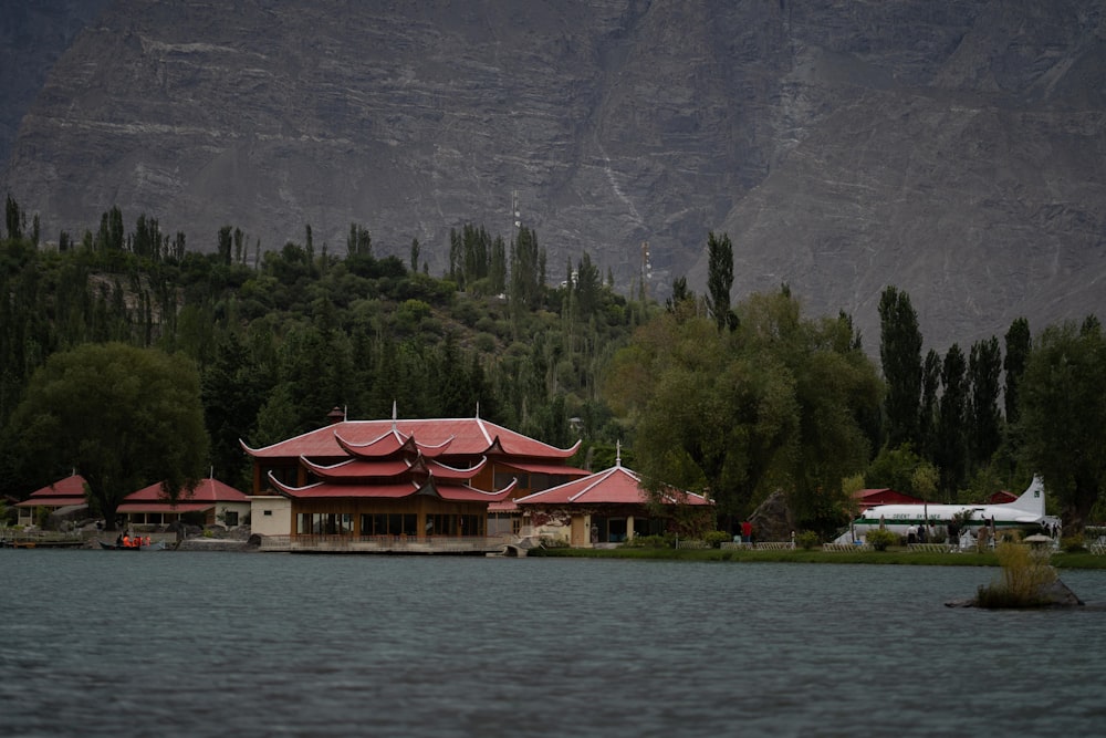 white and red house near body of water during daytime