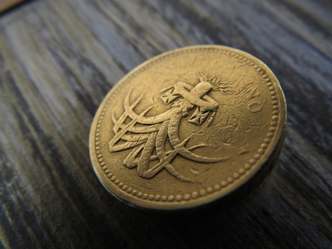 Close-up of a rare antique coin resting on a velvet cloth.