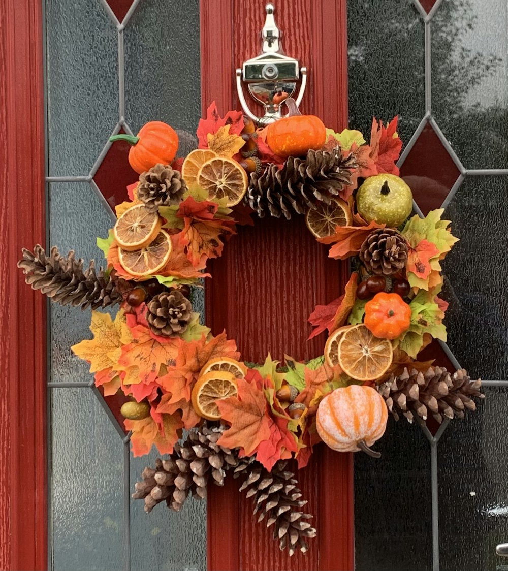 a wreath with oranges, pine cones and oranges