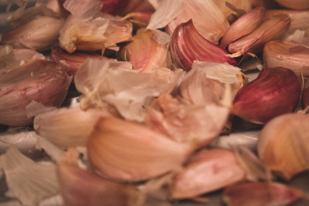 pink and white garlic on white surface