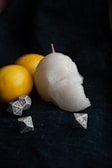 An overhead view of a voodoo doll surrounded by candles.