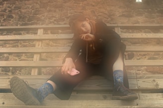 Socks displayed on a city bench, with a smartphone showing the TikTok challenge video in the background