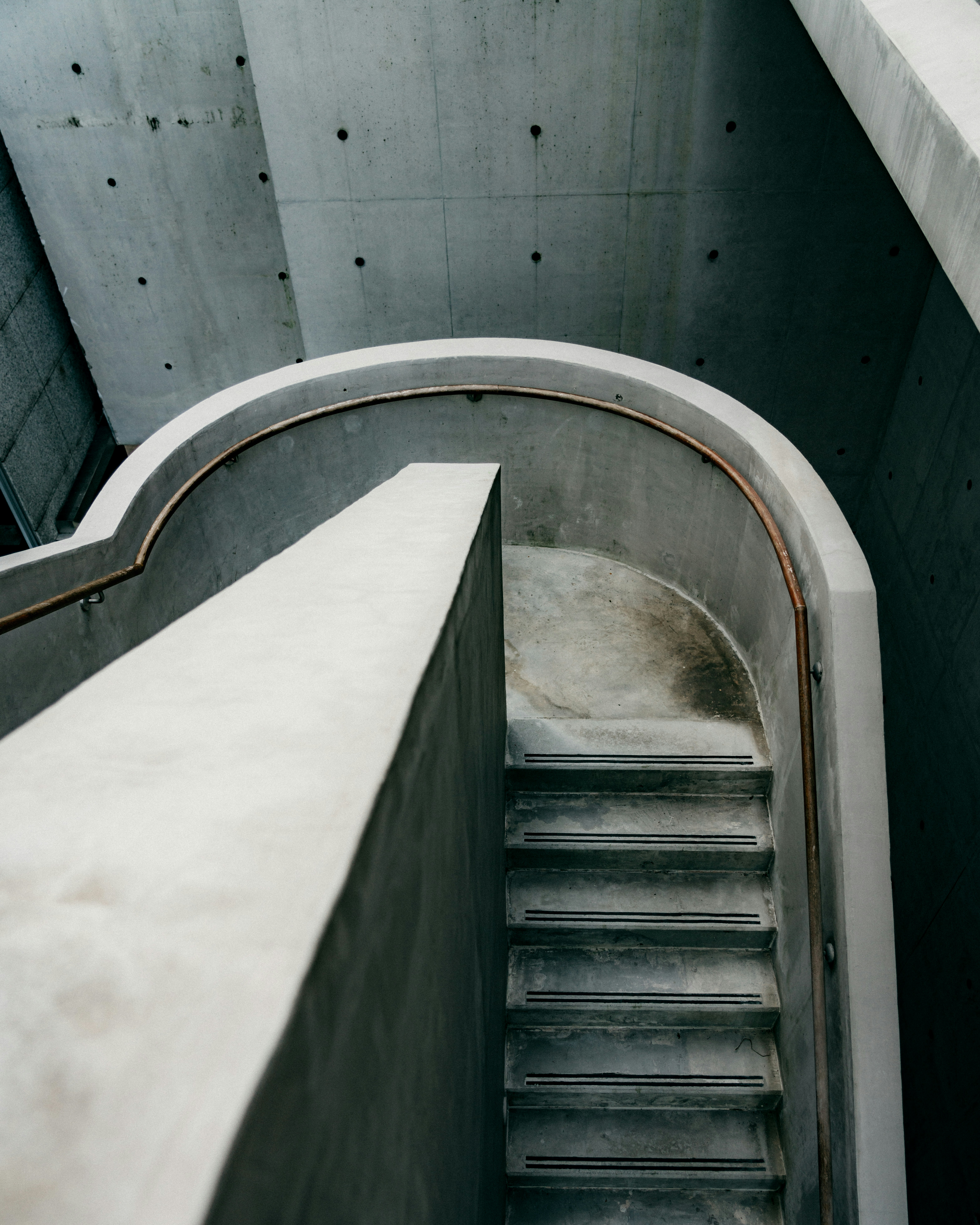white-concrete-staircase-with-stainless-steel-railings