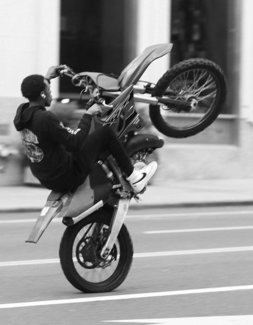man in black jacket riding motorcycle in grayscale photography