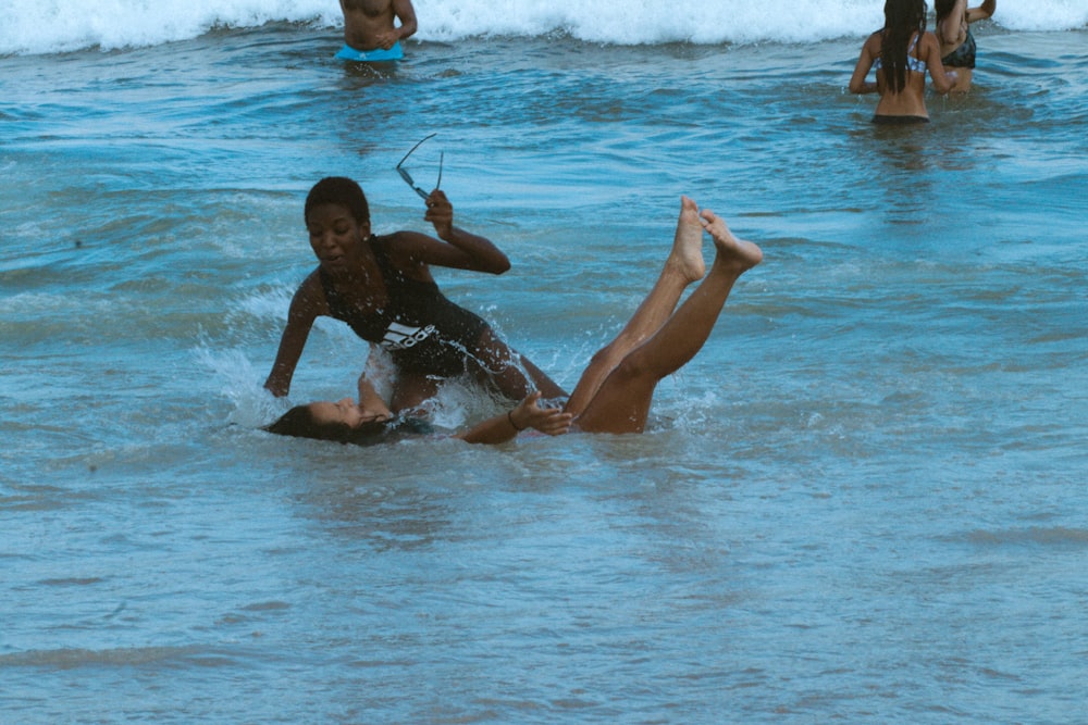 woman in black swimsuit on water during daytime