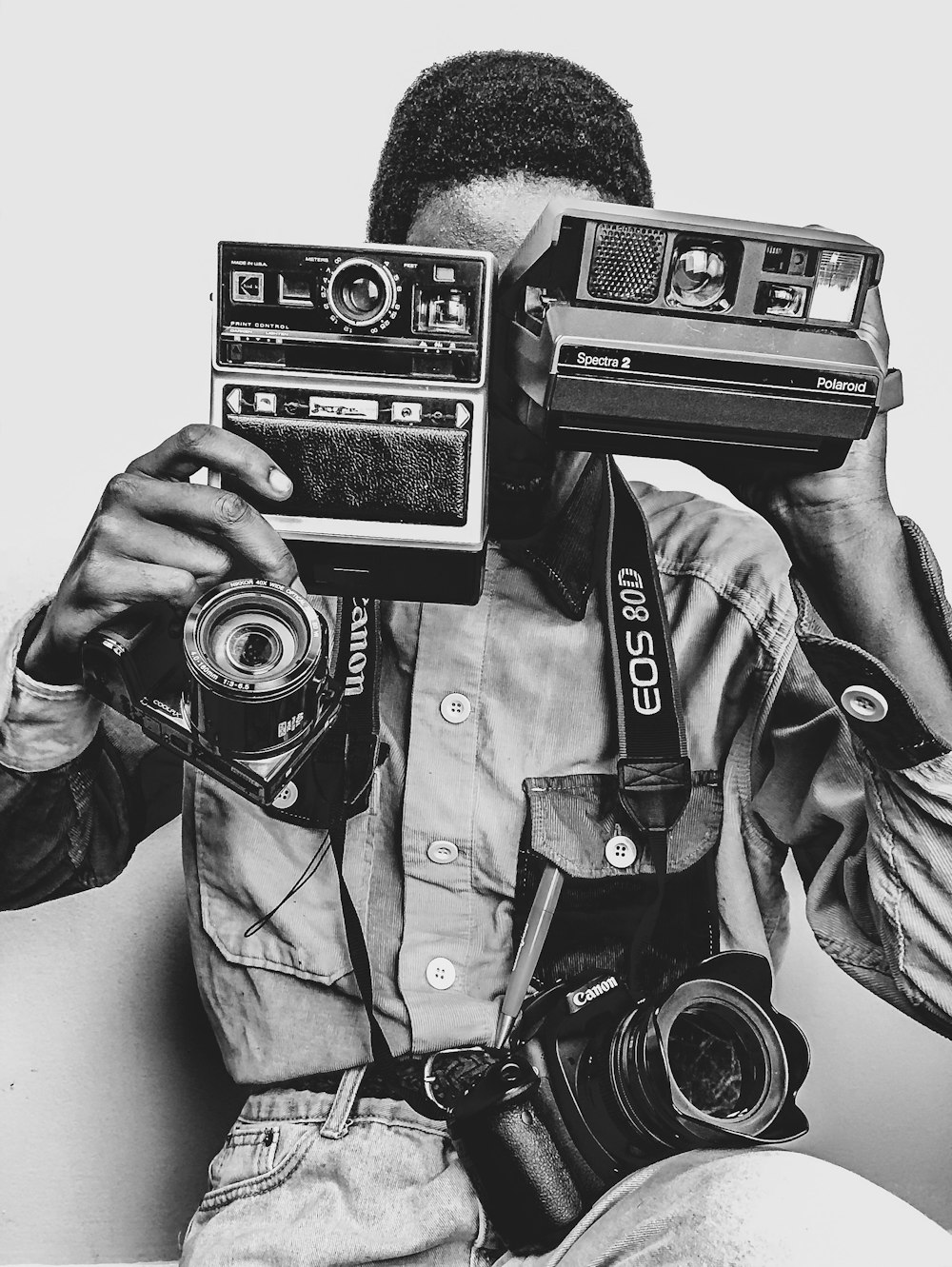 grayscale photo of man holding camera