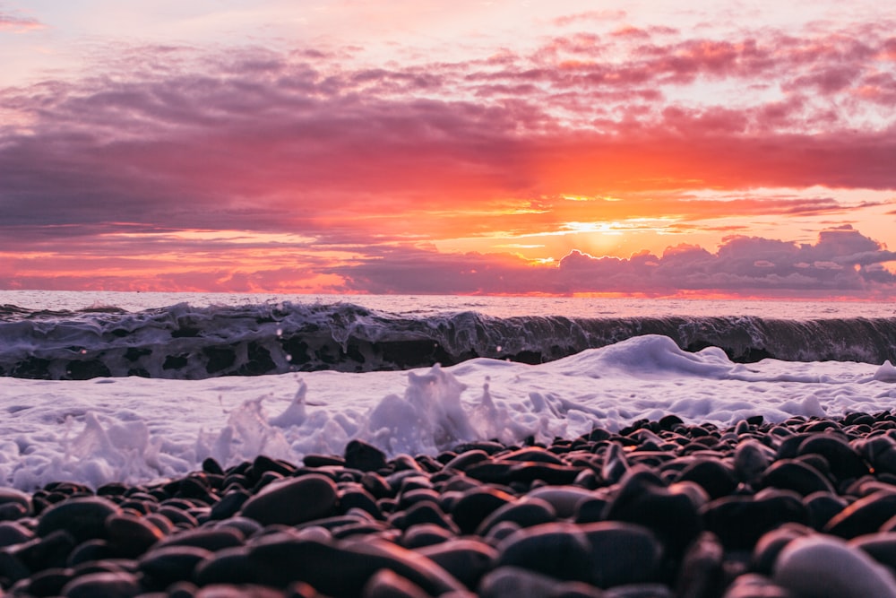 snow covered field during sunset