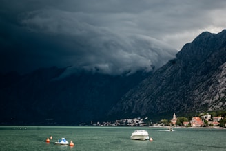 Cover image of After the Storm featuring a stormy sky over a quiet coastal town.