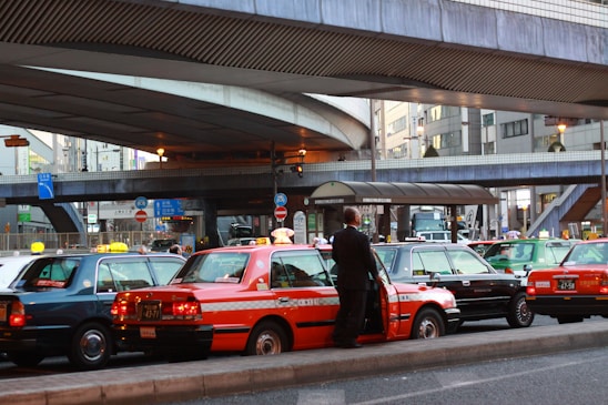A modern taxi parked in an urban setting, showcasing its sleek design and vibrant colors.
