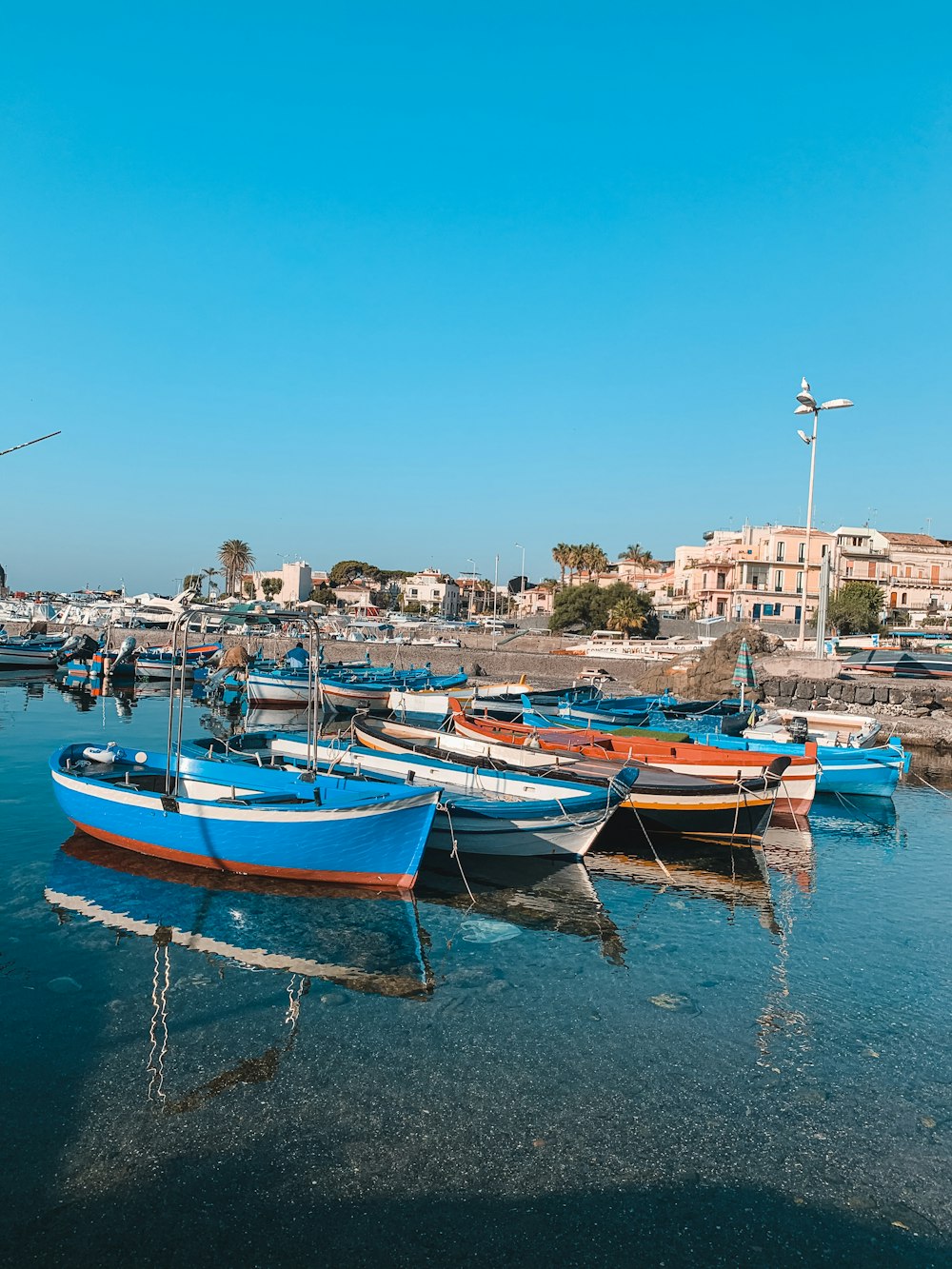 blue and brown boat on dock during daytime