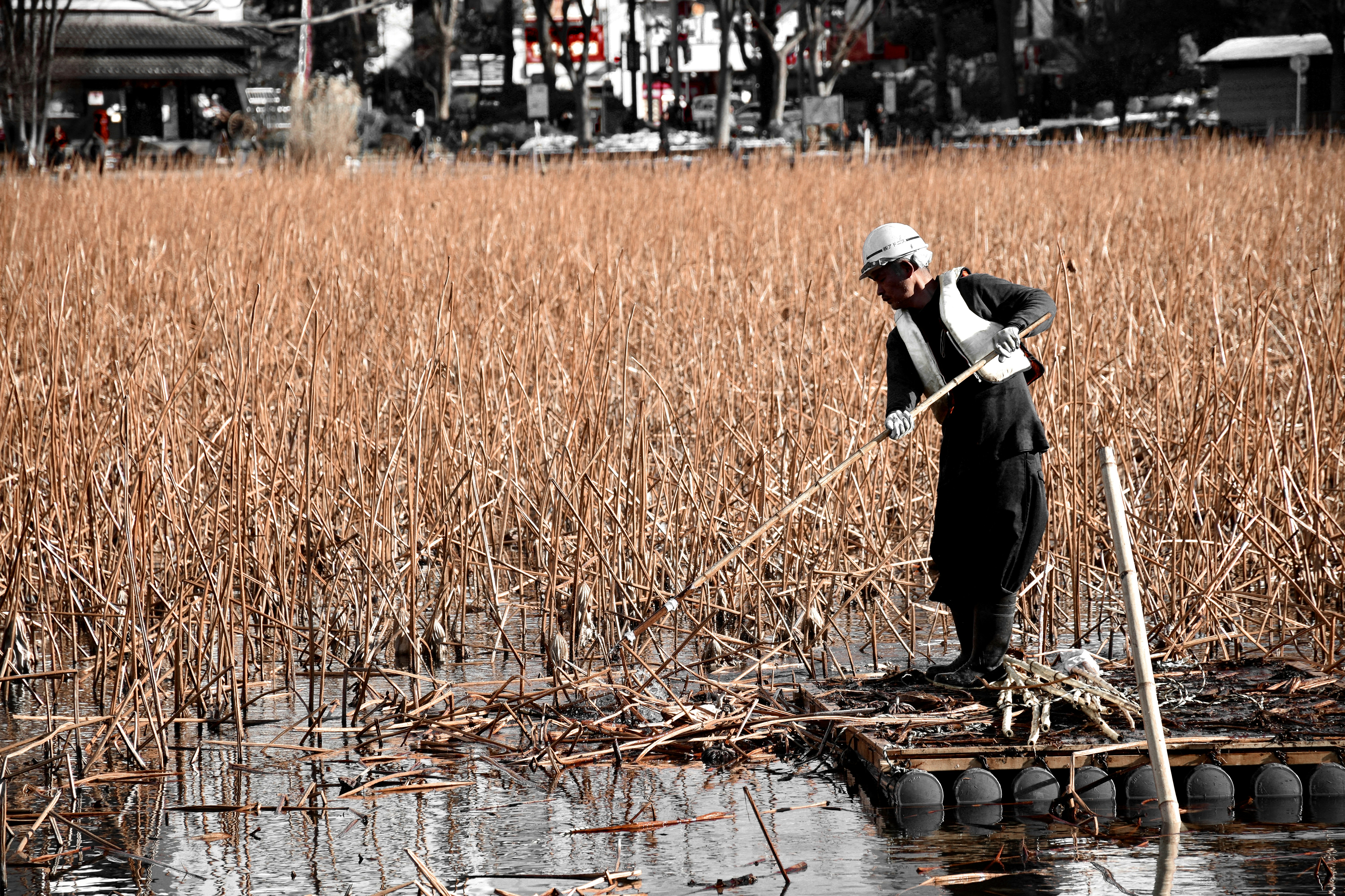 man in black suit walking on river during daytime