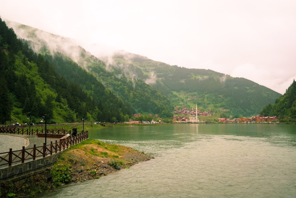 green mountain beside body of water during daytime