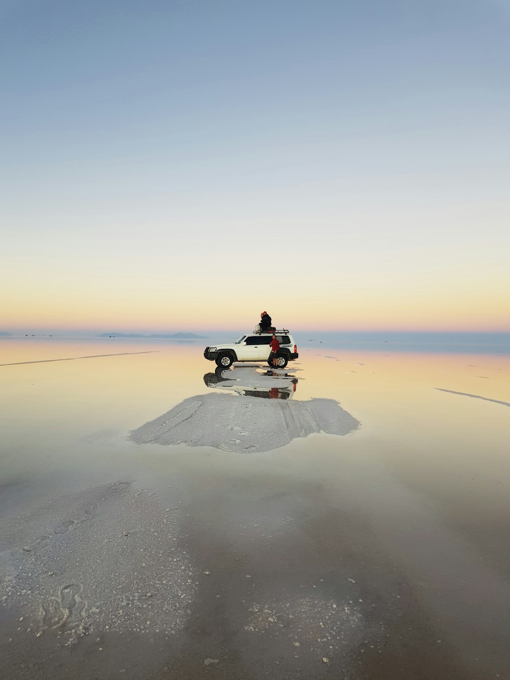 person sitting on sand during daytime