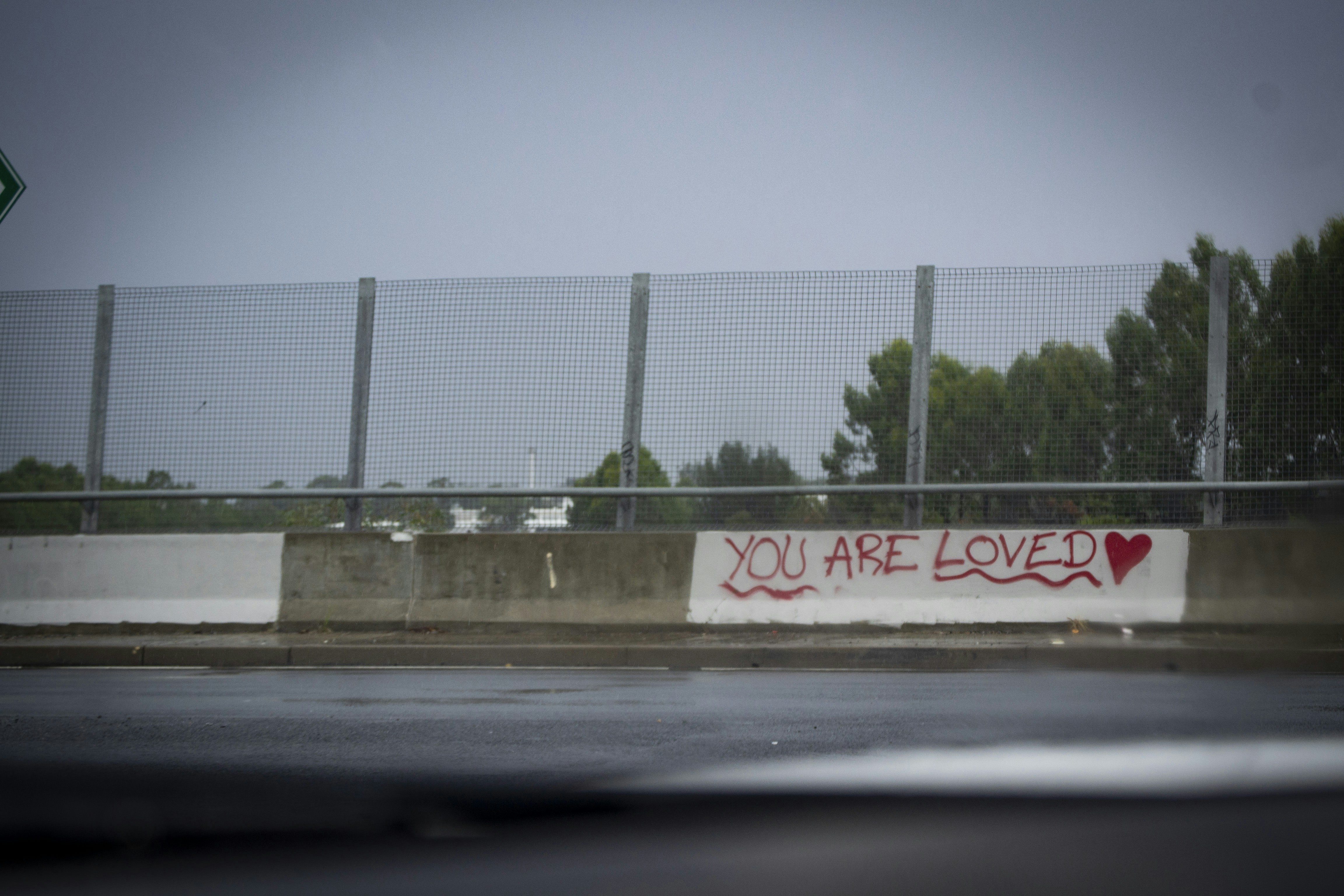 a fence that has graffiti written on it
