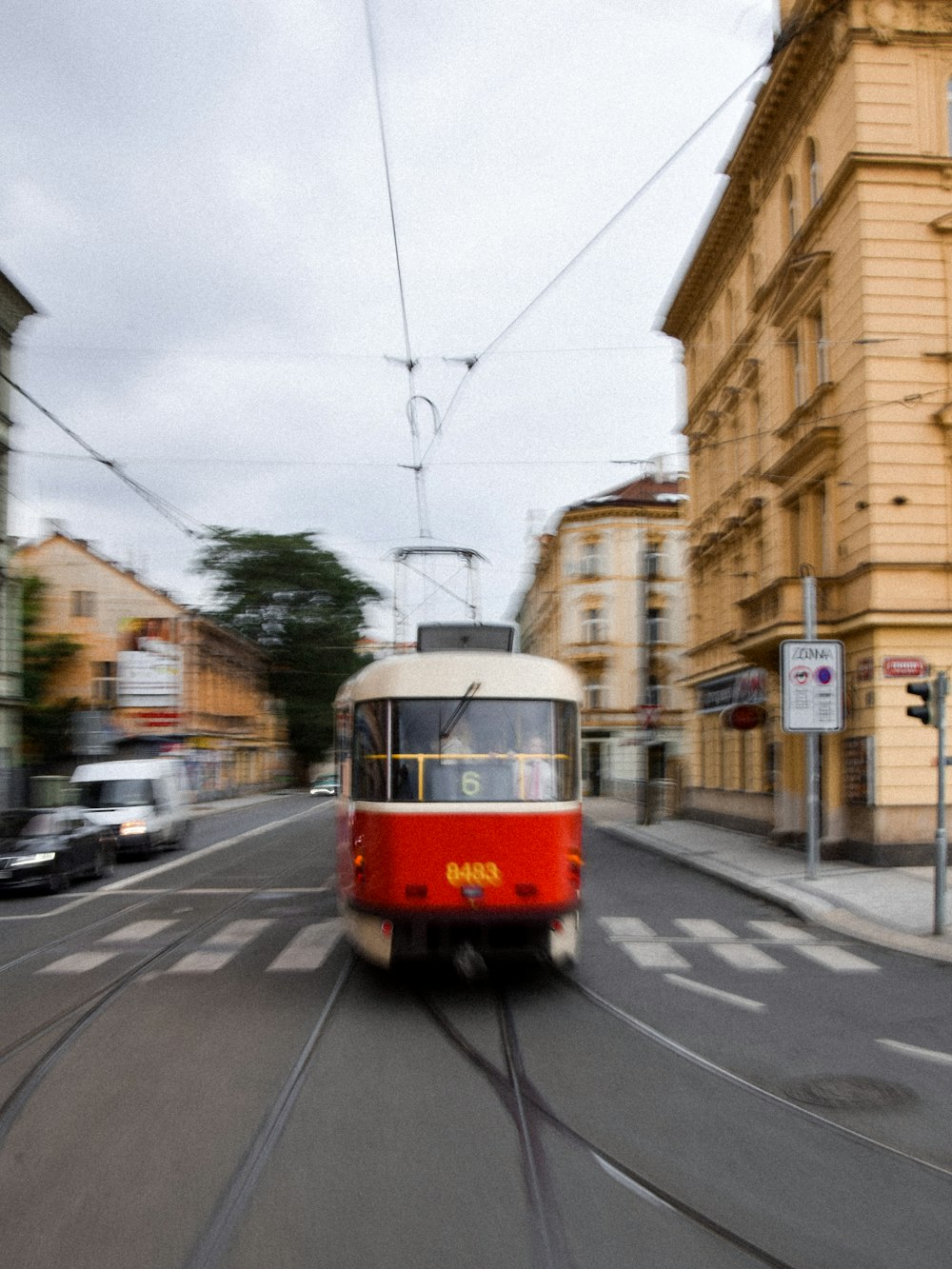 red and white tram on road during daytime