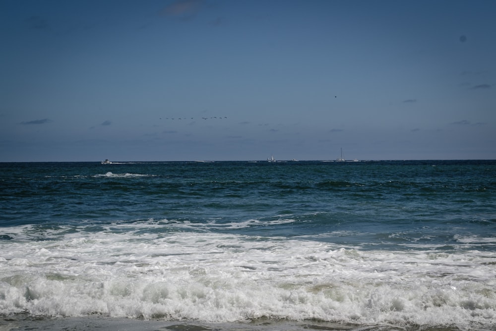 ocean waves under blue sky during daytime