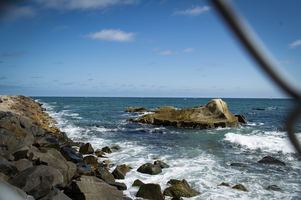 brown rocky shore under blue sky during daytime