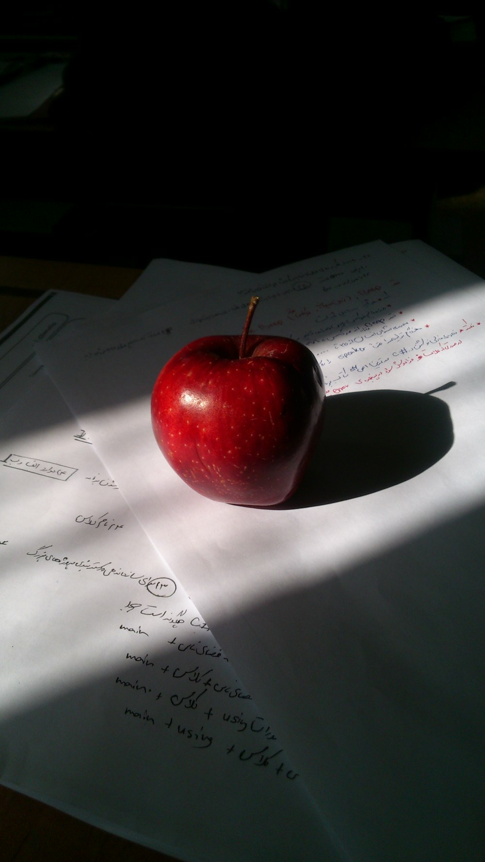 red apple on white printer paper