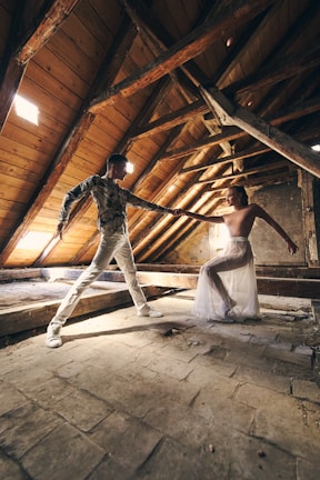 Two professional dancers performing a synchronized duo show in a stylish Airbnb setting.