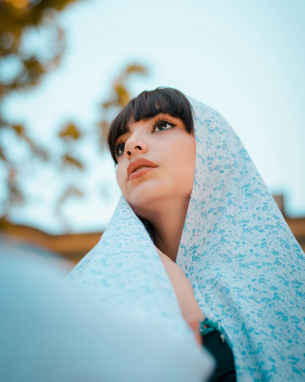 woman in blue scarf and teal shirt